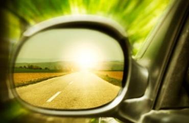 The highway reflecting in the rearview mirror of a vehicle