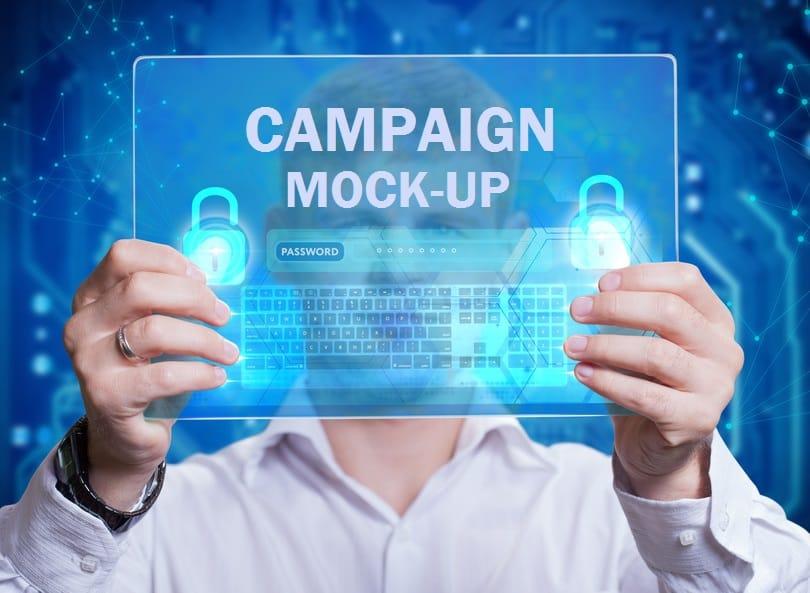 A man holding a screen in front of his face that reads "Campaign Mock-Up"