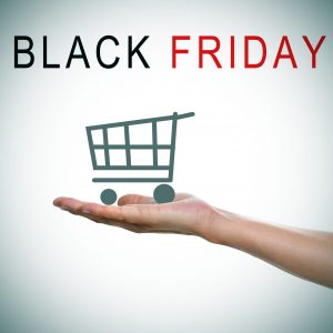 the text black friday and a man hand holding a shopping cart